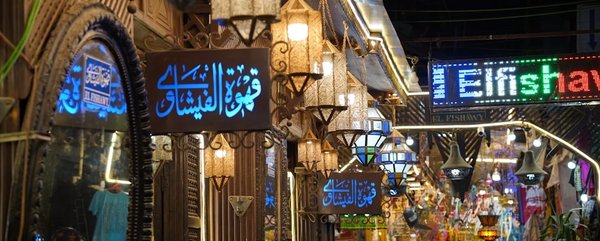 Khan el-Khalili market in Cairo with traditional lanterns and Arabic signs, romantic and lively atmosphere.
