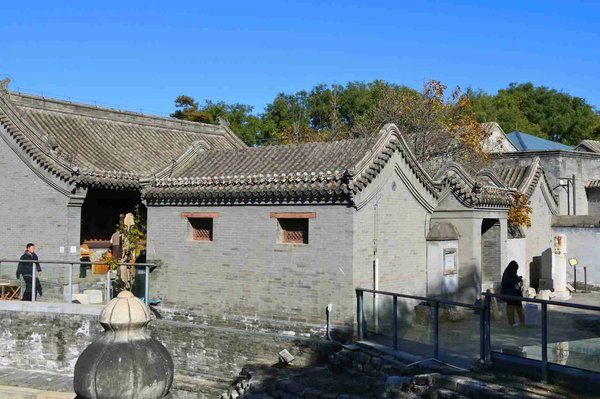 Traditional hutong architecture in Beijing with Chinese-style roofs and a sunny courtyard.