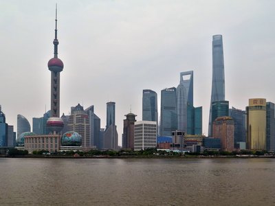 Night panoramic view of Shanghai's skyline with bright lights and iconic skyscrapers.