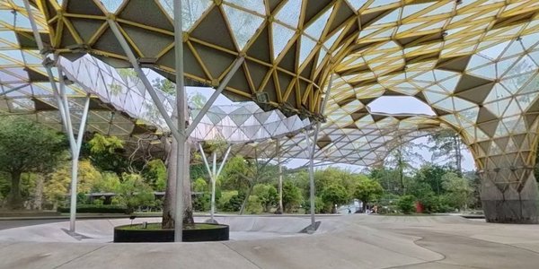 Geometric canopy structure at Perdana Botanical Garden in Kuala Lumpur, surrounded by trees and greenery.