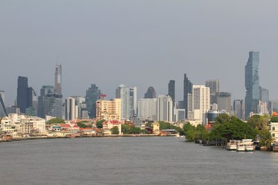 Bangkok skyline with the Chao Phraya River and the MahaNakhon skyscraper on a clear day.