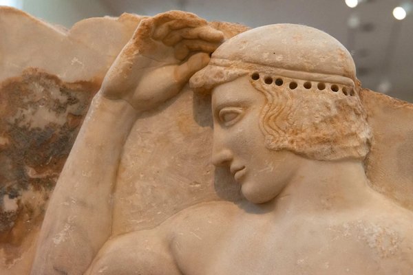 Classical marble sculpture displayed at the National Archaeological Museum of Athens.