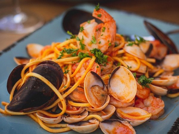 Seafood pasta dish with mussels, shrimp, and clams, typical of Amalfi cuisine.