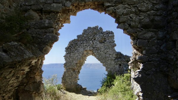 Ruins of Villa Jovis in Capri with a view of the sea and blue sky.