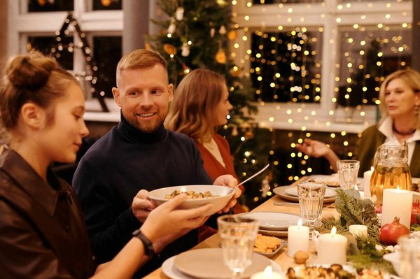 Christmas Eve dinner with festive decorations, twinkling lights, and a table set in a cozy atmosphere.