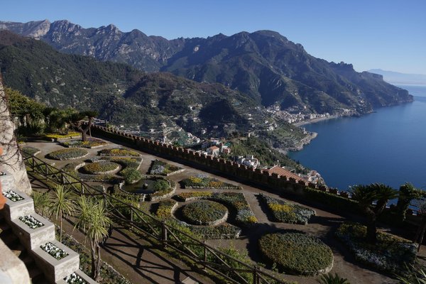 Ornamental garden terraces overlooking the Amalfi Coast and sea, evoking the Terrazza dell'Infinito at Villa Rufolo.