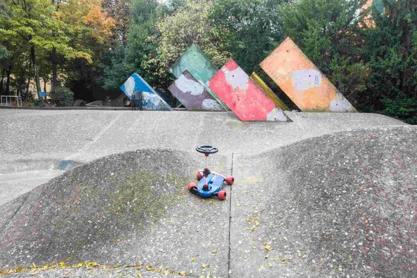 Colorful geometric sculpture in the Guasto Garden in Bologna with a toy in the foreground.