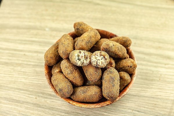Bowl of golden fried croquettes with a creamy filling.