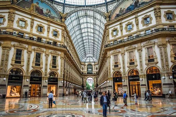 Interior of the Galleria Vittorio Emanuele II in Milan with its glass dome and Prada and Louis Vuitton storefronts.