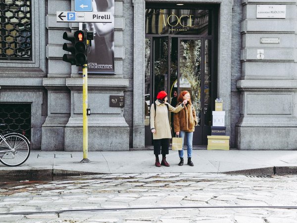 Two women in front of a luxury boutique on Via Manzoni in Milan's Quadrilatero della Moda.