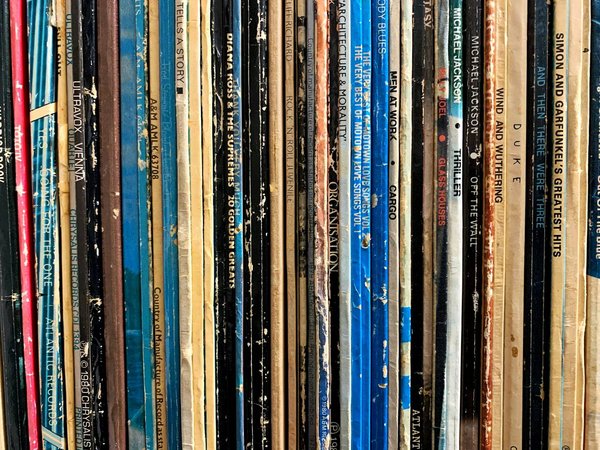 Close-up of a row of vintage vinyl records, the kind of collectible sold at Milan's flea markets.