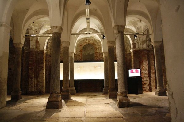 Interior of the Crypt of San Sepolcro in Milan with historic columns and arches.