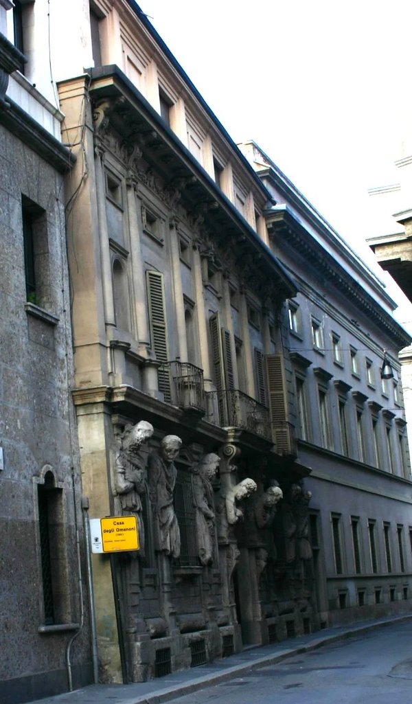 Facade of the House of the Omenoni in Milan with distinctive statues and architectural details.