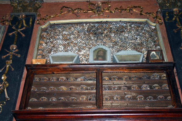Wall of skulls and bone-crosses inside the ossuary chapel of San Bernardino alle Ossa in Milan.