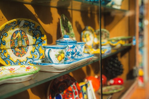 Colorful handcrafted ceramics on display, typical of the Aeolian Islands, featuring traditional patterns and vibrant details.