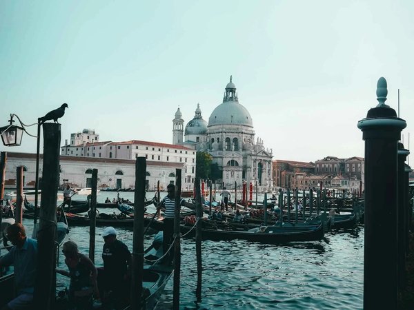 View of the Grand Canal in Venice with gondolas and the Basilica of Santa Maria della Salute in the background.