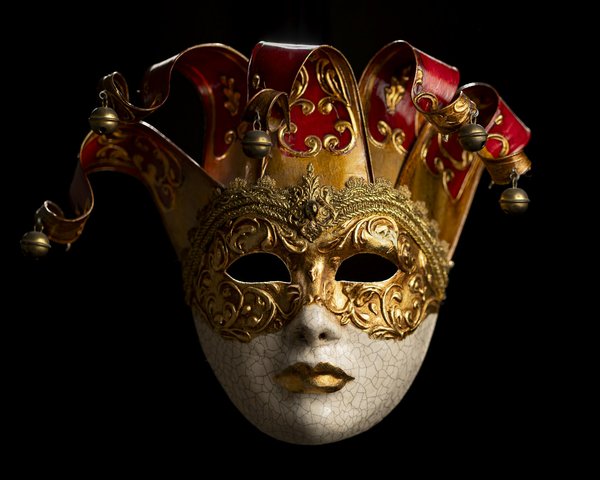 A gilded Venetian carnival mask with red and gold jester-style points and bells.