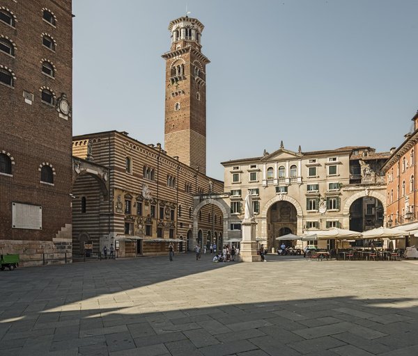 The Torre dei Lamberti rising above Piazza delle Erbe in Verona, seen from Piazza dei Signori.
