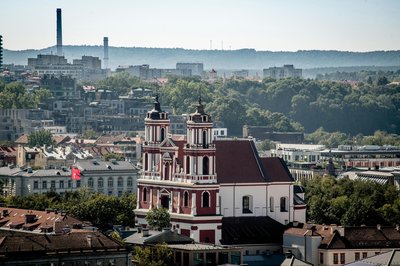 Panoramic view of Vilnius with St. Catherine's Church in the foreground and the cityscape in the background.
