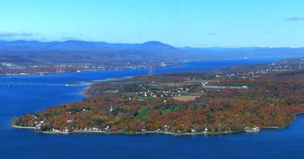Panoramic view of Île d'Orléans with autumn foliage and the St. Lawrence River near Quebec City.