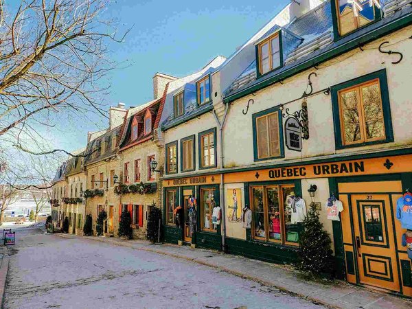 Picturesque street in Quartier Petit Champlain in Quebec with historic buildings and colorful shops.