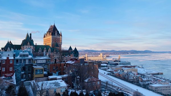 Winter view of Quebec City featuring Château Frontenac and the frozen river, an iconic symbol of the city.