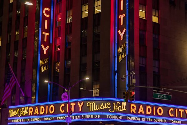 Facciata del Radio City Music Hall illuminata con luci al neon a New York durante il periodo natalizio.